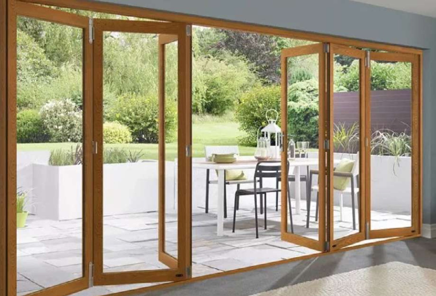 Wood folding patio doors open to a terrace